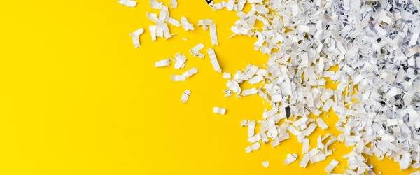 Shredded documents on yellow tray